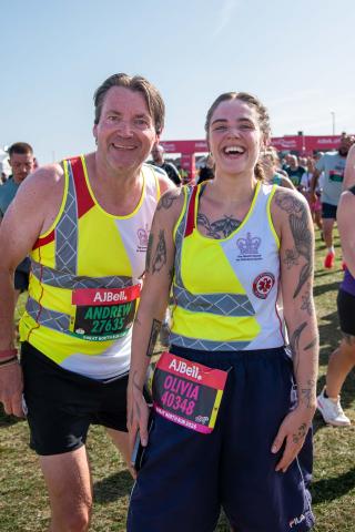 Two team blood bike runners smiling at the end of the race