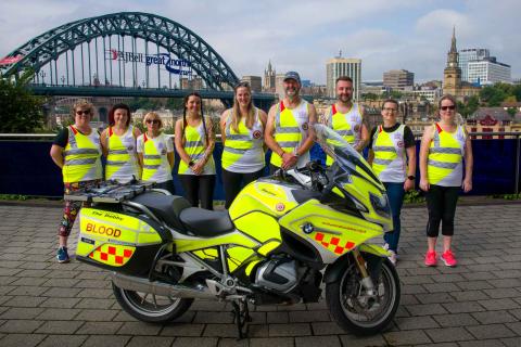 Team Blood Bikes runners in front of the Tyne bridge